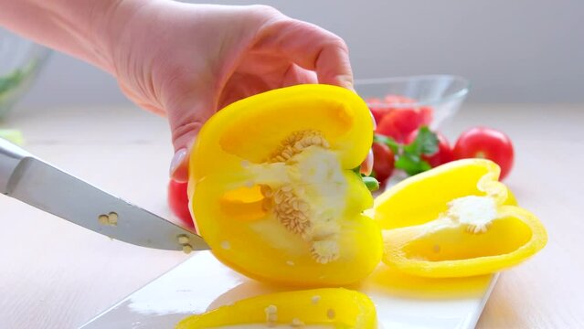 Closeup on cutting fresh bell pepper vegetables for cooking. High quality 4k footage