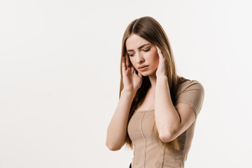 Fototapeta premium Migraine is a strong headache of girl isolated on white background. Overstressed young woman touches her head because of pain. Depression of attractive girl.