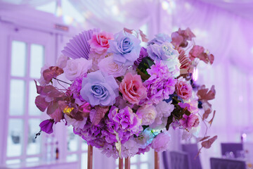 decoration of the served table with a bouquet on a stand