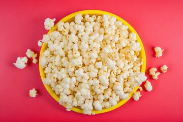 popcorn in a bowl on a red background