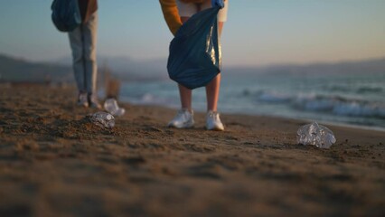 Mother with daughter saving the planet from garbage.