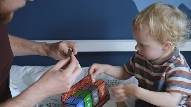 close-up father and son playing cards garbage sorting