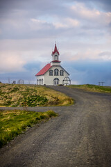 Small historic church in rural Iceland with overcast sky.