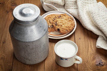 homemade cookies and cup of milk on wooden table