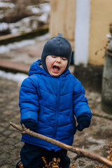 Naughty, screaming boy, child crying outdoors. Close-up photography, emotions, childhood concept,...