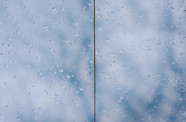 Home-made construction, a canopy, a greenhouse made of transparent cloth against the sky. Raindrops...