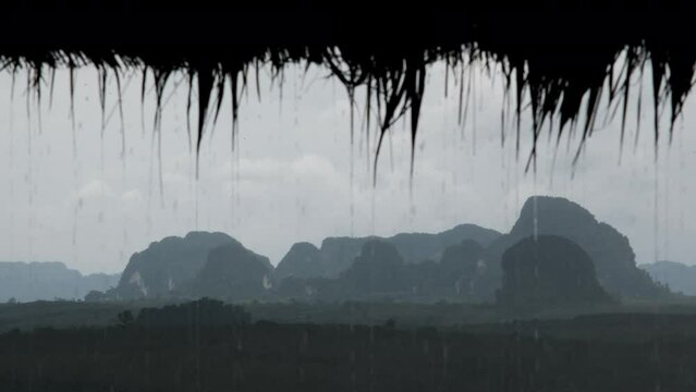 Tripod shot of karst rocks (in focus) at heavy rain (out of focus). Din Daeng Doi viewpoint, Krabi Province, Thailand.