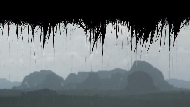 Tripod shot of karst rocks (out of focus) at heavy rain (in focus). Din Daeng Doi viewpoint, Krabi Province, Thailand.