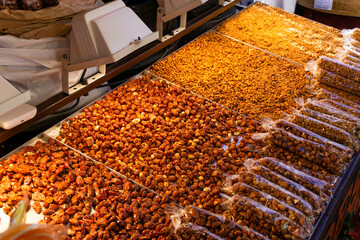 Different caramelized nuts on a stand