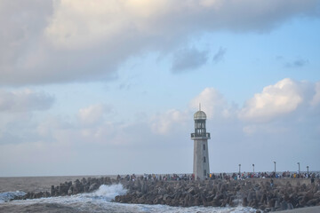 lighthouse and breakwater on the beachfront of damietta, Egypt on a misty and cloudy dusk