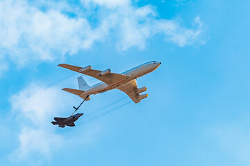 fueling a plane in the sky