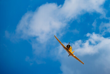Fototapeta na wymiar a yellow plane in the blue sky