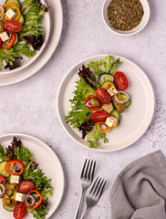 Food photography of  feta salad, greek, tomato, cucumber, onion, lettuce, sauce, bell, pepper, cheese, olive, vegetables