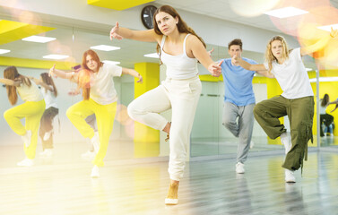 Young girl in sportswear dancing modern dances in dance studio