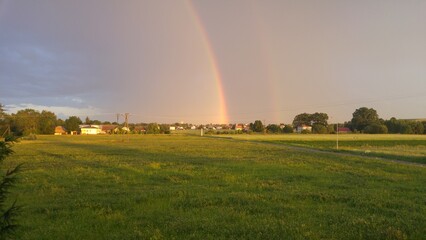 Rainbow in countryside sky