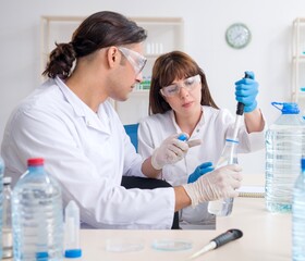 Two chemists working in the lab