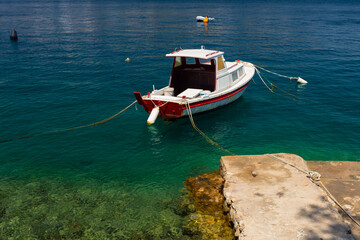 boat moored at the wooden pier in harbour of Losinj town, Croatia.