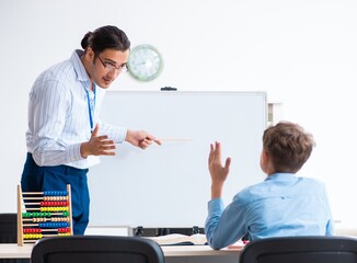 Fototapeta premium Young father helping his son to prepare for exam