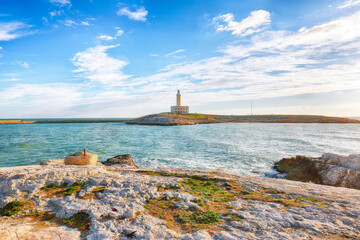 Fototapeta na wymiar Stunning view on Lighthouse of Vieste, rising on the isle of Santa Eufemia