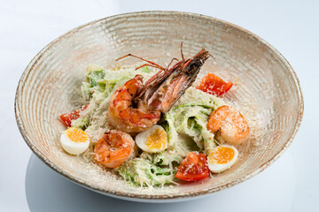 Italian Caesar salad with crayfish, shrimp, parmesan cheese, lettuce, egg, tomatoes, croutons.