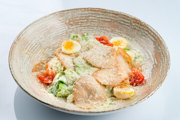 Italian Caesar salad with chicken, parmesan cheese, lettuce, egg, tomatoes, croutons.