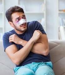 Young man recovering healing at home after plastic surgery nose