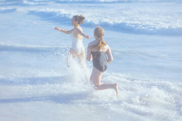 happy stylish mother and child at beach running