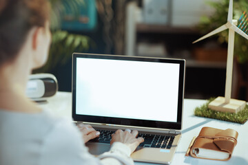 Seen from behind modern business woman with laptop blank screen