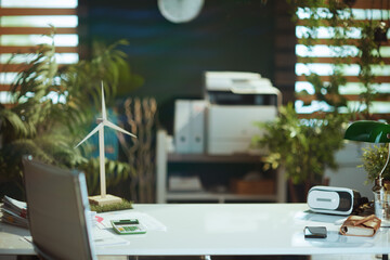 modern office with white desk, wind turbine and vr headset