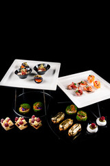 Appetizer restaurant menu white fish with sundried tomatoes, seared salmon, shrimp with cream cheese on a baguette, edible gold eclairs, raspberry cakes, shu and meringue with cream and strawberries.