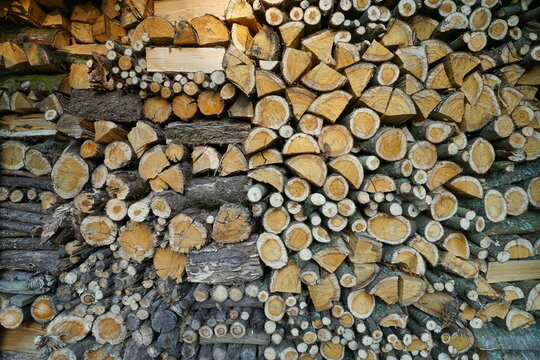 Full frame of firewood stacked, natural scene