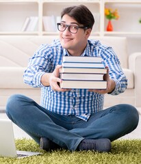 Young handsome man sitting on floor at home