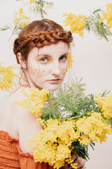 Portrait of a girl with yellow flowers