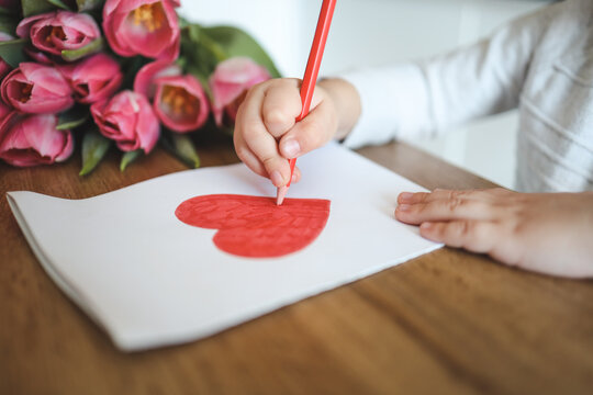 Child draws a card for mom on Mother's Day