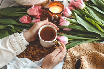 Girl holding a cup of tea in a cozy home interior