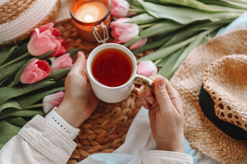 Girl holding a cup of tea in a cozy home interior