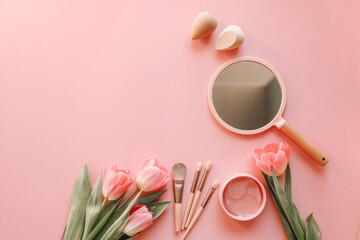 Cosmetic set top view flat lay on pink background
