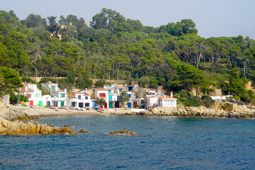 Fototapeta premium Cala s'Alguer, bay with old white fishing huts with colorful windows and door at the Mediterranean Sea, Costa Brava, Palamos, Catalonia, Spain