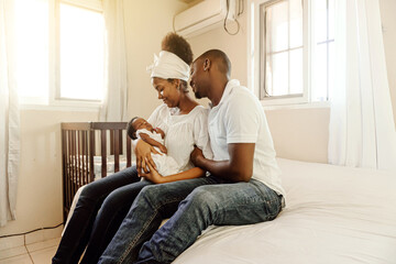 Parents together holding a new born. Family concept.