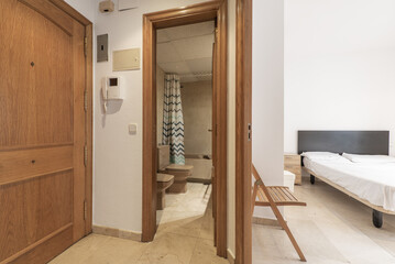 Studio apartment with access to a bathroom with brown porcelain toilets and cream marble floors