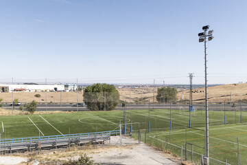 Fototapeta premium Several grass soccer training fields for youth and children's teams with lamp posts for lighting