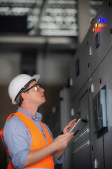 power engineer checks equipment at work and records readings