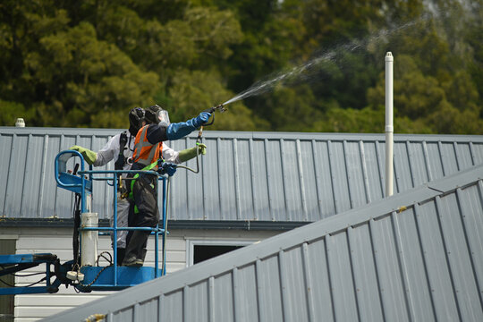worker spraying mould killer