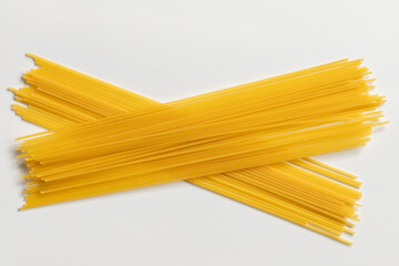 Uncooked spaghetti isolated on white background.