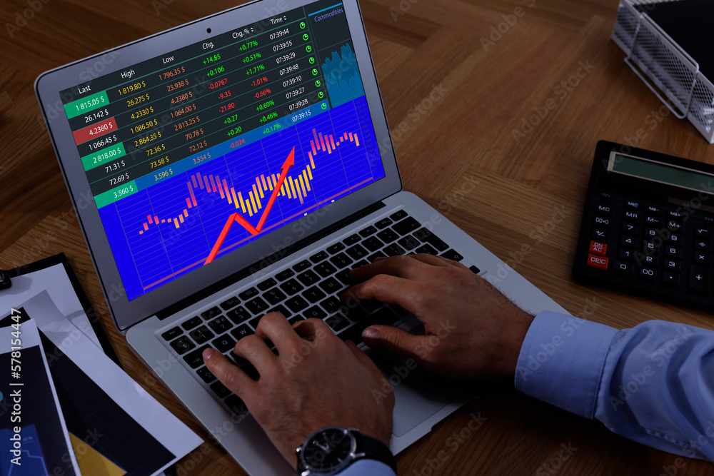 Poster man analyzing situation on stock exchange market via laptop, closeup. data and graph on screen