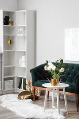 Interior of living room with flowers in vase and sofa