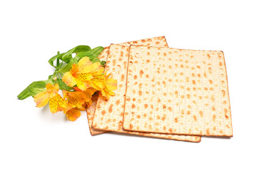 Jewish flatbread matza for Passover and beautiful alstroemeria flowers on white background