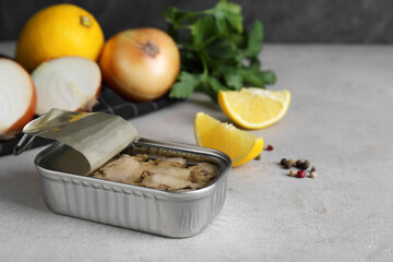 Open tin can of tasty cod liver on textured table, closeup. Space for text