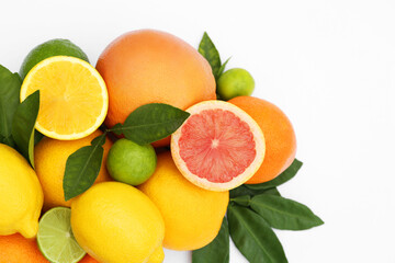 Naklejka na ściany i meble Different citrus fruits and leaves on white background, top view