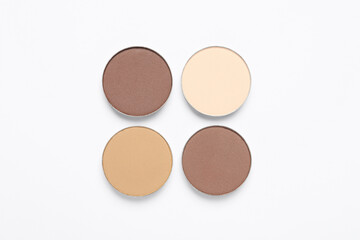 Beautiful eye shadow refill pans on white background, flat lay